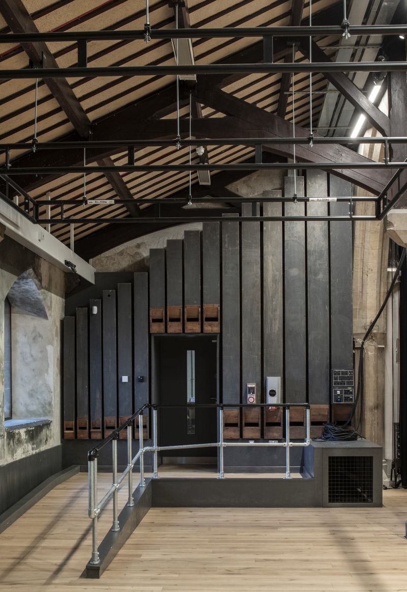 Repurposed organ pipes and pews at Fran Wen Nyth in Bangor church retrofit, with accessibility ramp
